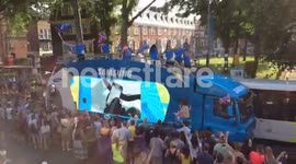 Crowds in good spirits as the sponsor floats proceed the Olympic torch