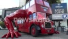 Double Decker Bus doing press ups outside Czech house