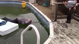 Dad in hilarious frozen pool cannonball fail