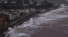 Dramatic scenes as huge waves batter Dawlish sea wall and station.Beach huts smashed.