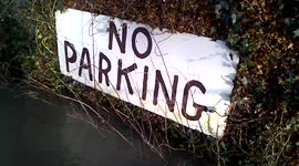 Lotus Excel trapped in flood water by no parking sign