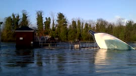 wrecked boat on bell weir on the thames at egham
