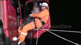 Firefighters rescue people trapped in lorry hanging off a cliff
