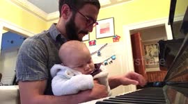 Father sings his sick baby to sleep