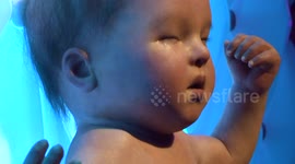 Creepy robot baby moves and cries