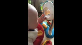 6 month old baby laughing in a jumperoo toy