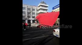 Strong wind blows down the roof of a building