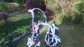 Christmas cracker! Aussie Santa decorates tree for his kids with homemade cannons - and even uses a drone to hang the star