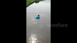 Golfer rescues a golf trolley from lake & even goes back in for the putter.