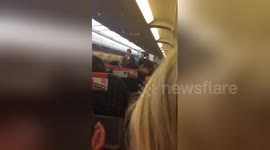 Newsflare Edit - Passengers cheer as rowdy yobs escorted off Easyjet flight