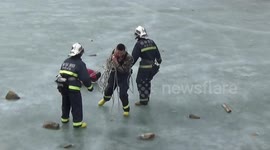 Firefighters rescue a boy trapped on icy lake