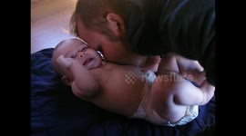 Father Tickles and Kisses Laughing Baby - Dad and 3-month-old