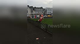 Man trips on railing while trying to jump over it