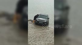 Range rover is nearly washed out to sea after trying to launch rib into water