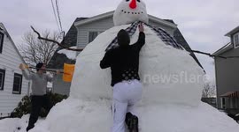 Group of friends build a 15-foot-tall snowman