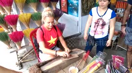 Tourist learning how to make incense sticks in Hue Vietnam