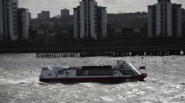 Boat bravely makes its way through a choppy River Thames during storm