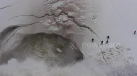 Tourists play dangerous games close to waterfall