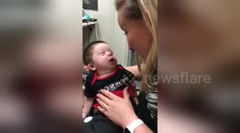 Three-month-old baby hears parents' voices for the first time