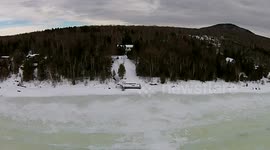 Man takes 'dronie' on shore of a frozen lake in Canada