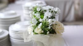 Wedding dinner preparation, beautiful flowers and white plates, selective focus, 4K