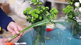 A florist preparing a centrepiece flower composition for the wedding catering  in Italy, selective focus, 4K