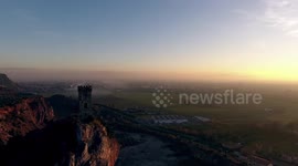 Aerial shot, Upezzinghi tower on the rocky outcrop in Italy, Tuscany, on the sunset light, filmed with drone, 4K