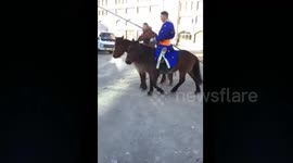 Students in traditional clothes ride horses to school