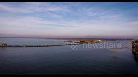 Aerial shot of small port in the winter sunset in Pisa Tuscany Italy filmed with drone, 4K