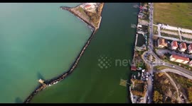 Aerial shot of some fishermen houses with huge nets outside on the Arno river in Tuscany Italy filmed with drone