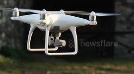 Slow motion video of a white quadcopter drone hovering in an ancient italian town, HD