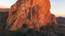 Aerial shot, Upezzinghi tower on the rocky outcrop in Italy, Tuscany, on the sunset light, filmed with drone, 4K