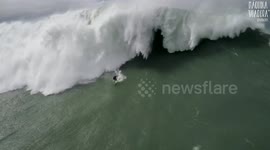 Drone captures giant wave surfing and dramatic rescue in Portugal's Nazare