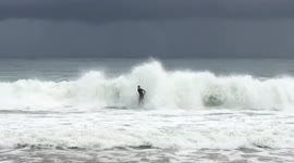 Australian surfers enjoy a late evening surf in big swell