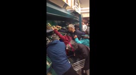 Shoppers fight for reduced price produce at Tesco supermarket