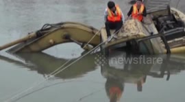 Firefighters rescue man from sunken floating excavator