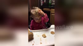 Baby smears peanut butter all over herself