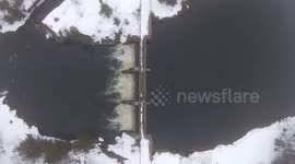 Beautiful drone footage from a dam on a misty winter day