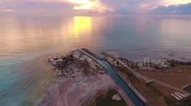 Aerial shot, gorgeous calm sea in the sunset light  in Italy, 4K