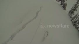 Avalanche knocks skier off cliff