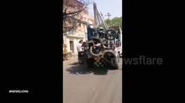 Traffic cops towing away a motorbike with the rider on it