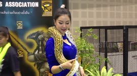 Presenter poses with a python in Thailand