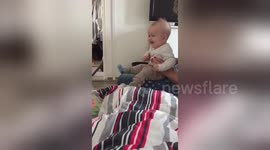 Baby can't stop laughing at puppy playing fetch