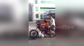 Girl drives motorcycle with dad in fast speed on road
