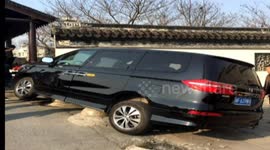Car turning a corner crashes into wall in China