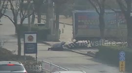 Scooter driver falls down in time to escape being hit by lorry