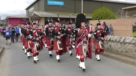 Inverness Royal British Legion Pipe Band parade runners in Scottish highlands, joined by one late addition