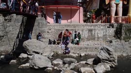 Man doing pooja on a few live snakes. Could be checkered keelback or Asiatic water snake (Xenochrop
