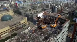Excavators work on top of high building in central China