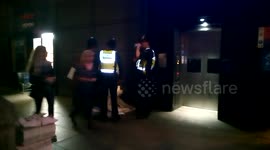 Police confront a Chinese homeless women at Westminster Station,London,UK